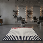 Modern salon interior with striped rug, chairs, and shelves.