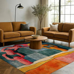 A vibrant, contemporary hand-tufted wool area rug with abstract patterns in red, blue, and orange hues, perfectly complementing a modern living room. The square area rug lies beautifully under a round wooden coffee table, surrounded by mustard-colored sofas, creating a cozy and stylish space. Ideal for dining rooms or as a large living room rug 8x10, this rug adds a touch of elegance and comfort.