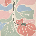 A vibrant area rug featuring an abstract floral design with bold pink, blue, and green petals. This contemporary wool rug is perfect for adding a touch of elegance to your living room decor.