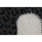 Close-up view of the Little Black Leopard Hand Tufted Wool Rug showcasing its intricate texture and durable backing, perfect for enhancing living room decor. This large area rug, crafted from high-quality wool, adds a touch of elegance to any living room space.