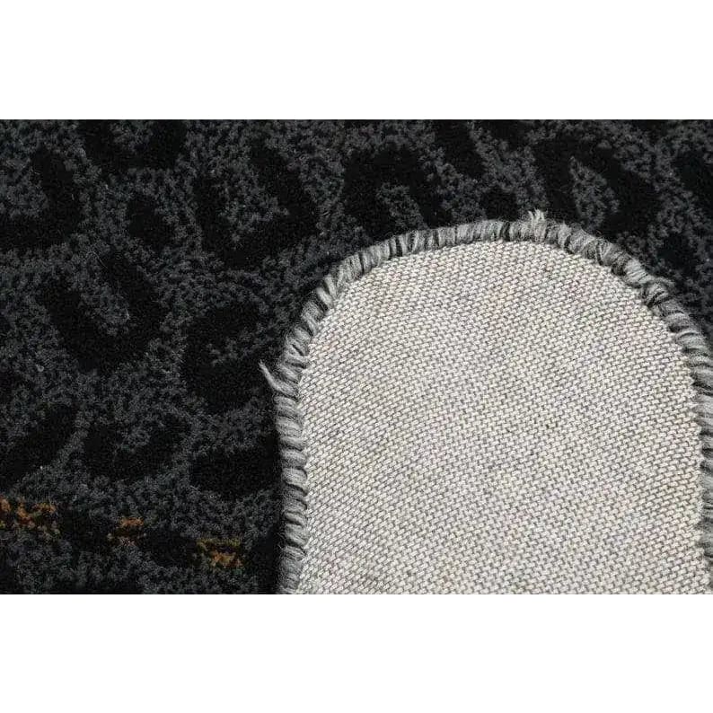 Close-up view of the Little Black Leopard Hand Tufted Wool Rug showcasing its intricate texture and durable backing, perfect for enhancing living room decor. This large area rug, crafted from high-quality wool, adds a touch of elegance to any living room space.