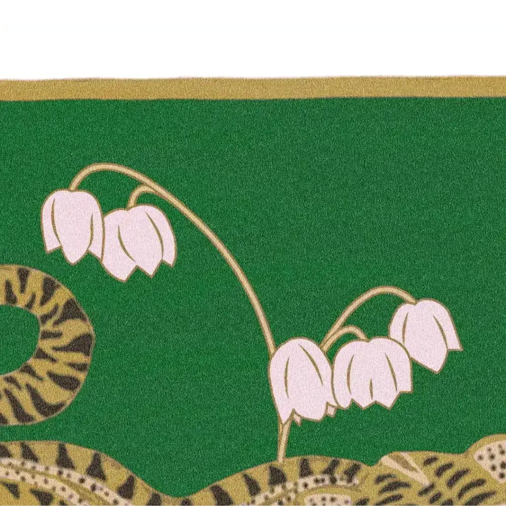 Close-up view of the Lotus and Indian Tiger Hand Tufted Wool Rug in green, showcasing intricate floral and tiger stripe patterns. This elegant area rug is perfect for adding a touch of boho style to your dining room or living room, and is made from high-quality wool, making it a durable choice for large area rugs and dining room carpets.
