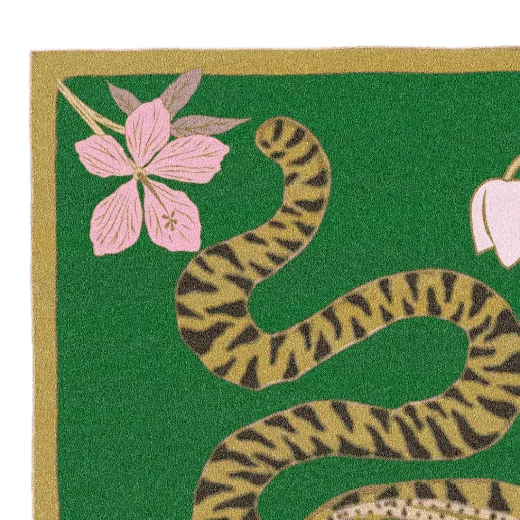 Close-up view of the Lotus and Indian Tiger Hand Tufted Wool Rug in green, showcasing a vibrant tiger stripe pattern intertwined with delicate pink flowers. This wool rug is ideal for dining rooms, adding a touch of boho style to large area spaces, perfect for both living room and dining room settings.