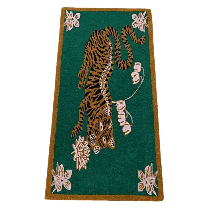 A vibrant hand-tufted wool area rug featuring an abstract tiger design set against a rich green background. Perfect for adding a touch of boho style to dining room carpets or as a centerpiece in living room and dining room rugs. The large area rug showcases elegant lotus flowers, making it a stylish addition to any space.