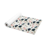 Lotus Reflection yoga mat partially rolled, pink lotus and navy bloom print on pale cream ground
