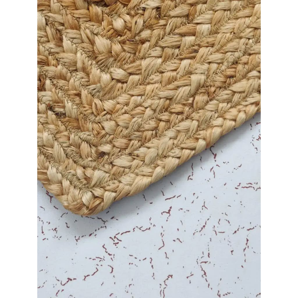 Close-up view of a Love Heart Shape Jute Rug, showcasing its natural woven texture. This area rug is perfect for enhancing dining room spaces with its rustic charm, ideal as a round rug or dining room carpet. The large area rug is crafted from high-quality jute, adding a warm and earthy touch to any room.