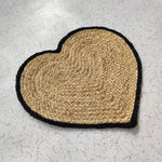 A beautifully crafted heart-shaped area rug made from natural jute, perfect for adding a touch of charm to your dining room. This round rug, with its intricate woven pattern and black border, doubles as a stylish dining room carpet and is ideal for those seeking large area rugs with a unique design.