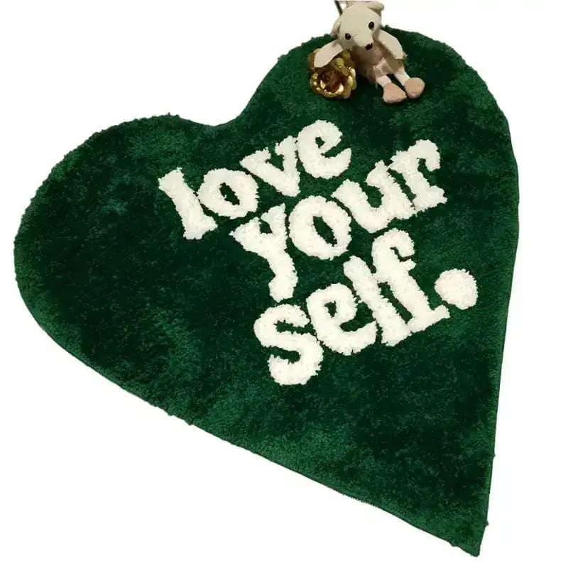 Heart-shaped area rug in rich green with 'love your self' text, perfect for adding a cozy touch to area rugs for living room settings.