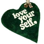 Heart-shaped area rug in rich green with 'love your self' text, perfect for adding a cozy touch to area rugs for living room settings.