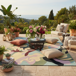 Outdoor patio with colorful rug, flowers, and furniture