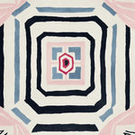 Top view of a Lucid Growth Totem Hand Tufted Rug, showcasing an abstract geometric design with concentric shapes in black, blue, and pink. This contemporary area rug, made from high-quality wool, is perfect for adding a modern touch to living room decor.