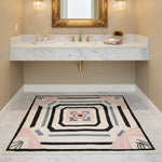 Bathroom with a decorative rug on the floor, featuring geometric patterns.