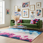 Modern living room with a green sofa, colorful rug, and abstract art on the wall.