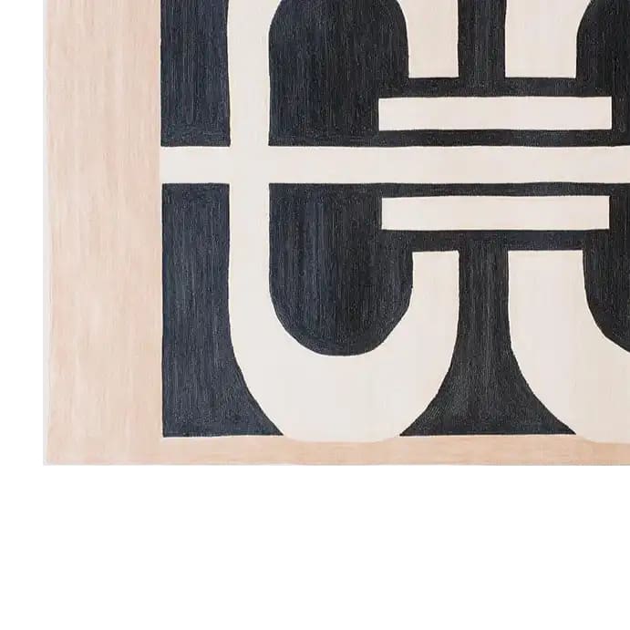 Close-up view of the Lunar Cascade Knotted Wool Rug showcasing its bold, abstract black and white geometric design. This contemporary rug, made from high-quality wool, is perfect for adding a modern touch to living room spaces. Ideal as a centerpiece among area rugs, it brings both style and comfort to any home.