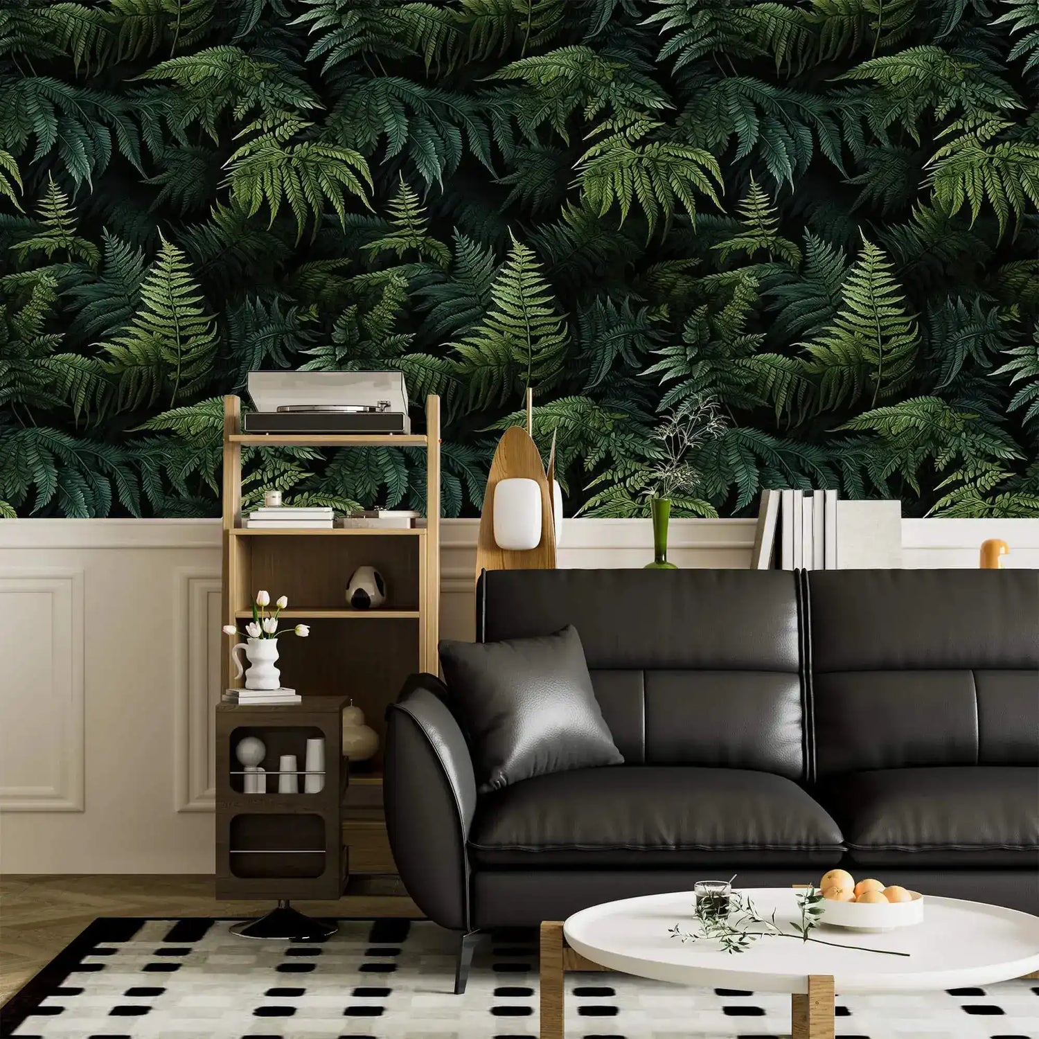 Lush green fern jungle wallpaper above white panelling with black leather sofa and shelf