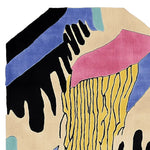 Vibrant and artistic Lush Lines Hand Tufted Area Rug featuring an abstract design in black, blue, pink, and yellow, perfect for contemporary living room settings. This wool rug adds a bold touch to large living room spaces.