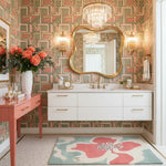 Bathroom with geometric wallpaper, floral rug, and decorative mirror.