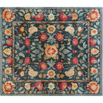 The Lush Petals Hand Tufted Rug showcases a vibrant floral design with rich red, yellow, and cream tones on a deep teal background. This wool area rug is perfect for adding a vintage touch to your living room or dining room, combining elegance and warmth.