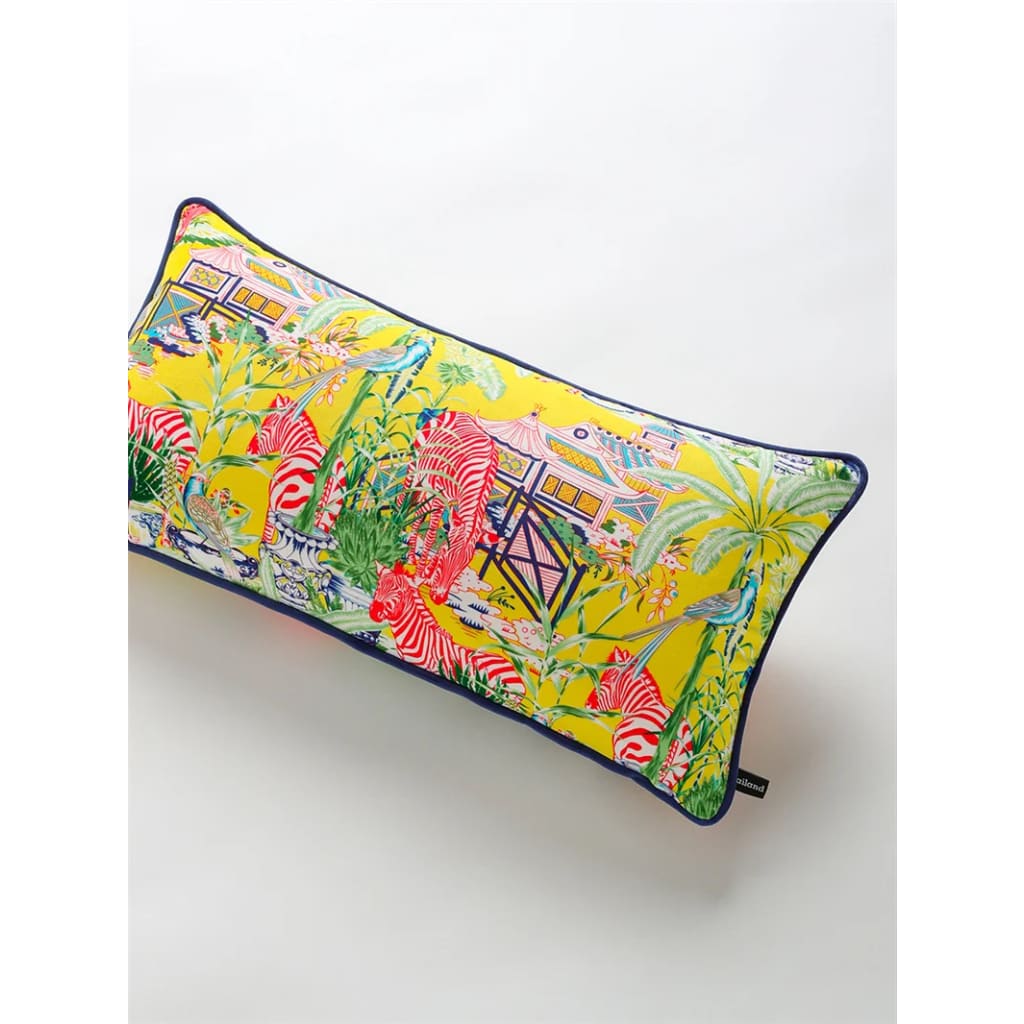 Luxurious lemon throw pillow featuring a vibrant pagoda and zebra design surrounded by tropical foliage