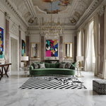 Luxurious living room with a green sofa, an abstract wool rug, colorful artwork, and marble floor.