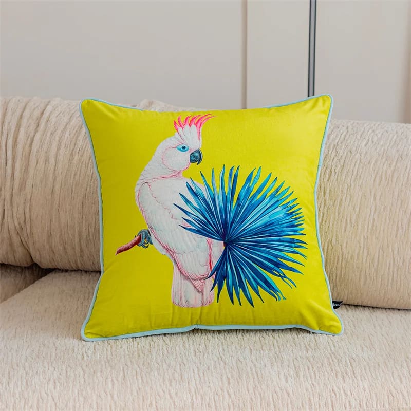 Luxurious tropical throw pillow featuring a colorful cockatoo design on a vibrant yellow background, perfect for accenting home decor.
