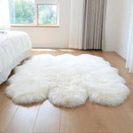 A luxurious plush soft sheepskin area rug placed on a wooden floor in a bright bedroom. The large living room rug, ideal for 8x10 spaces, adds warmth and elegance to the room with its fluffy texture and pure white color, complementing the natural light coming from the window.
