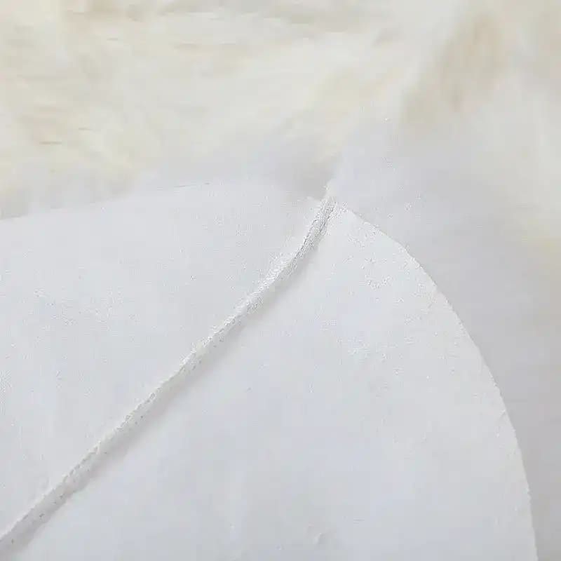 Close-up view of a luxurious plush soft sheepskin rug, showcasing its fine texture and quality. Ideal as a large living room rug, perfect for those seeking elegant and cozy living room rugs 8x10.