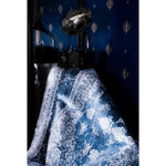 Luxurious hand-tufted wool area rug draped elegantly, showcasing intricate patterns in a sophisticated dining or living room setting. Perfect for adding a touch of elegance to living room and dining room spaces.