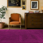 A contemporary magenta geometric area rug made from hand-tufted wool, enhancing a formal dining room setting. The rug, perfect for large dining room carpets, features an intricate pattern that adds a modern touch to the elegant space.