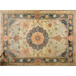 This image showcases a magnificent floral hand-knotted area rug, perfect for adding a vintage touch to your living room. The intricate design features a central medallion with vibrant floral patterns, reminiscent of traditional Persian rugs. The rug's rich colors and detailed craftsmanship make it an ideal choice for those seeking elegant area rugs for living room spaces.
