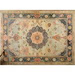 This image showcases a magnificent floral hand-knotted area rug, perfect for adding a vintage touch to your living room. The intricate design features a central medallion with vibrant floral patterns, reminiscent of traditional Persian rugs. The rug's rich colors and detailed craftsmanship make it an ideal choice for those seeking elegant area rugs for living room spaces.