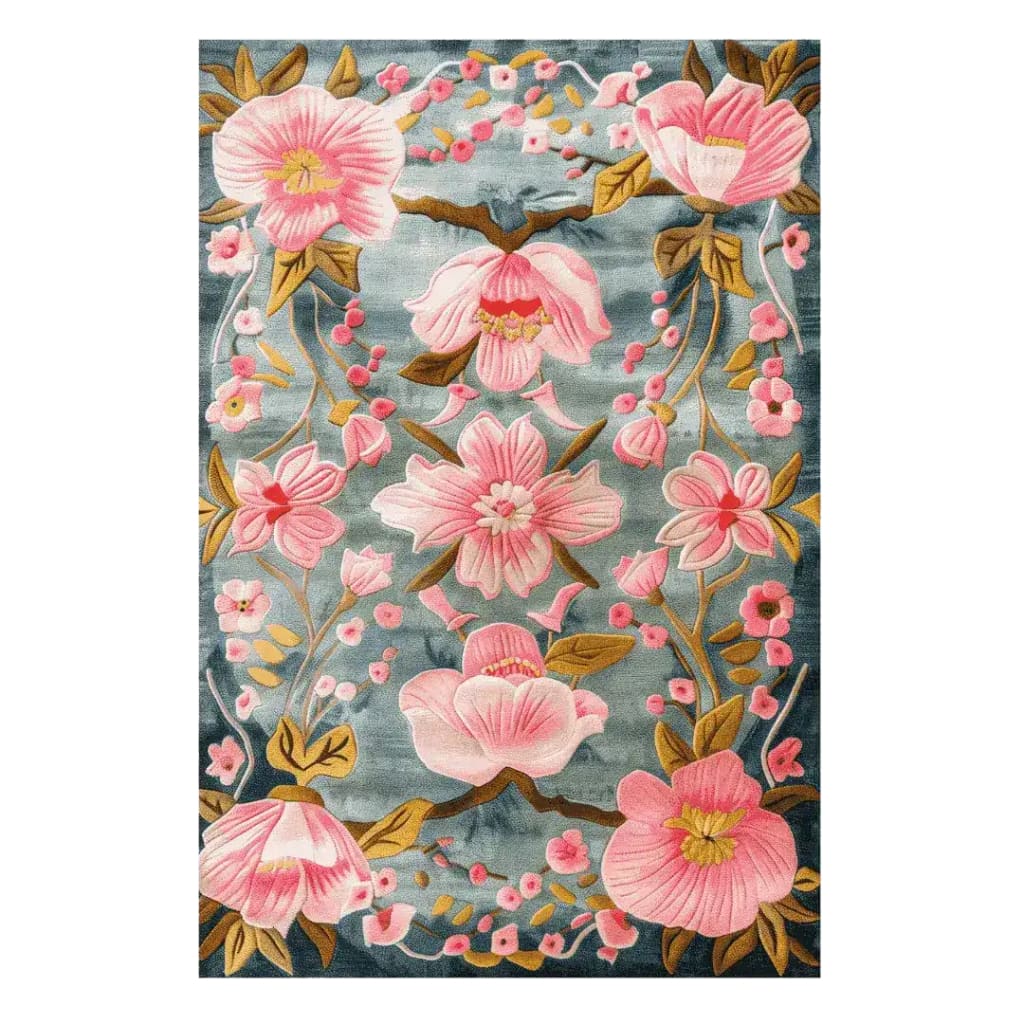 A beautiful Magnolia Blossom Hand Tufted Area Rug featuring a vibrant floral design. The rug showcases large pink magnolia flowers on a subtle blue background, perfect for adding elegance to a dining room or large living room. This wool rug is ideal for those seeking floral rugs for living room spaces.