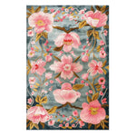A beautiful Magnolia Blossom Hand Tufted Area Rug featuring a vibrant floral design. The rug showcases large pink magnolia flowers on a subtle blue background, perfect for adding elegance to a dining room or large living room. This wool rug is ideal for those seeking floral rugs for living room spaces.