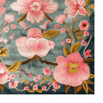 Elegant Magnolia Blossom hand-tufted area rug, showcasing vibrant pink floral patterns against a soft gray background. This wool rug adds a touch of sophistication to dining rooms or large living rooms, offering a perfect blend of style and comfort.