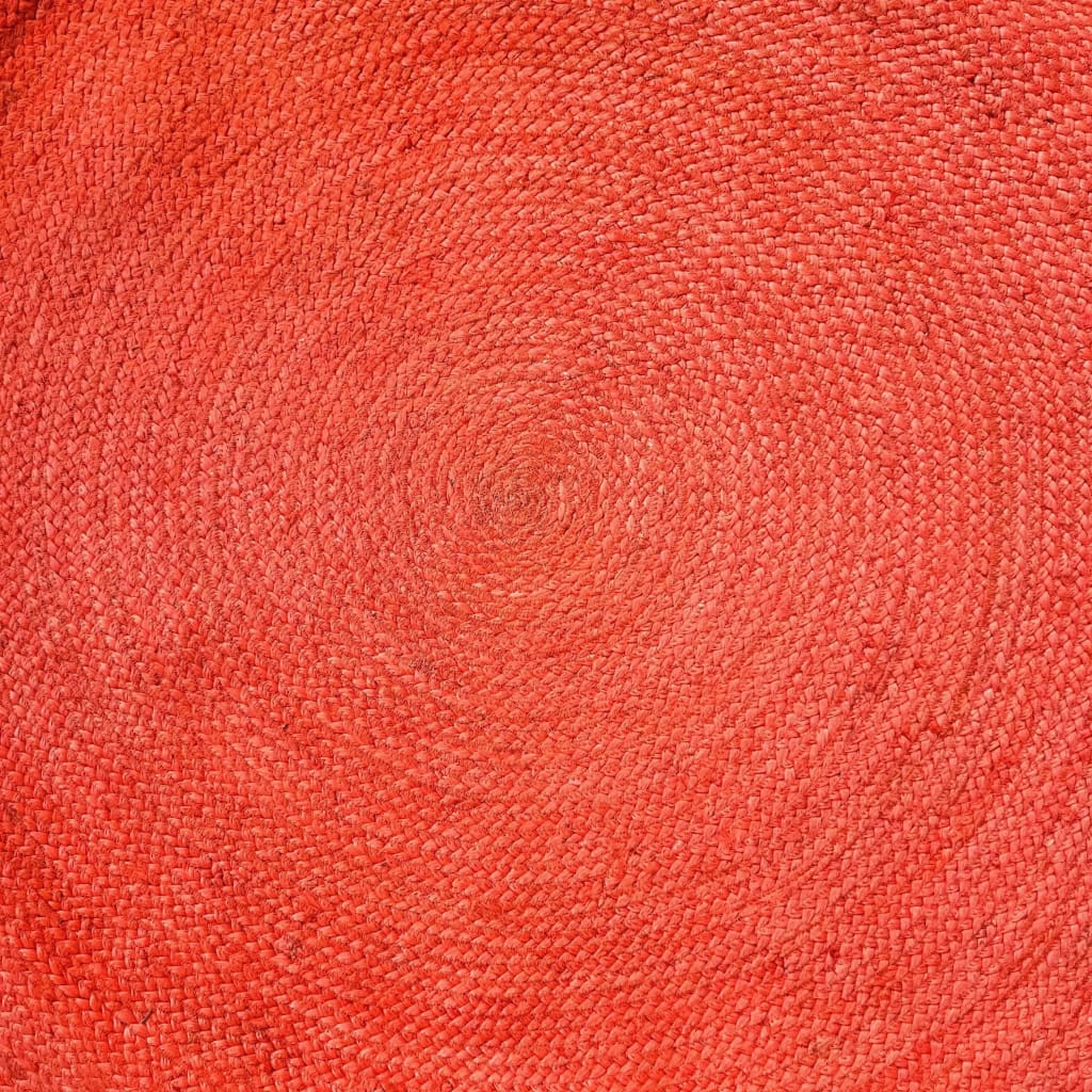 Top view of a vibrant red, round jute area rug with a woven texture, perfect for adding a splash of color to large living room spaces. This stylish living room area rug highlights intricate craftsmanship, ideal for those seeking unique large area rugs.