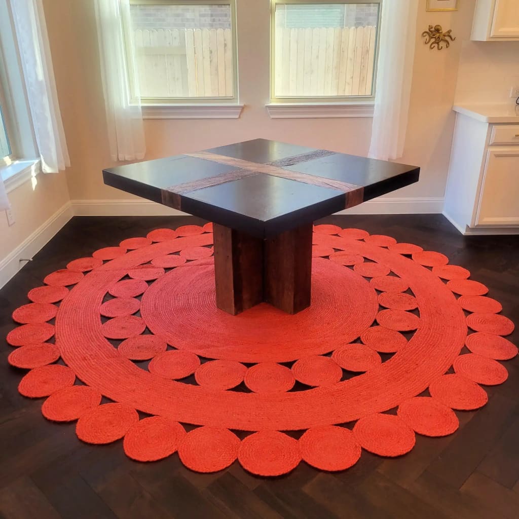 Stylish round jute area rug in vibrant red, perfect for large living rooms. The rug's intricate circular design adds a touch of elegance, enhancing any living room setting.