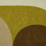 Close-up of a textured rug with green, brown, and beige colors.