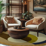 A cozy living room featuring the Maia Golden Brown Round Hand Tufted Wool Rug. This elegant area rug serves as the perfect bedroom or living room centerpiece, with its rich golden brown hues and round shape complementing the modern decor. The soft wool texture adds warmth and style to any space, making it an ideal choice for bedroom area rugs or as a standout piece in your living room.