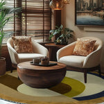 A cozy living room featuring the Maia Golden Brown Round Hand Tufted Wool Rug. This elegant area rug serves as the perfect bedroom or living room centerpiece, with its rich golden brown hues and round shape complementing the modern decor. The soft wool texture adds warmth and style to any space, making it an ideal choice for bedroom area rugs or as a standout piece in your living room.