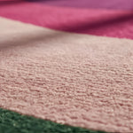 A vibrant and contemporary round rug crafted from wool, featuring a striking abstract design in shades of golden, pink, and purple. Perfect for adding a touch of modern elegance to a living room, this large area rug measures 8x10 and is ideal for those seeking stylish area rugs for living room spaces.