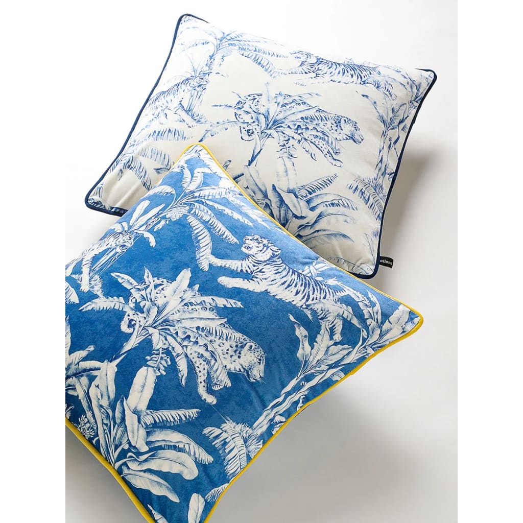 Exquisite jungle-print throw pillows featuring vibrant blue and white designs with tigers and tropical foliage, perfect for home decor.