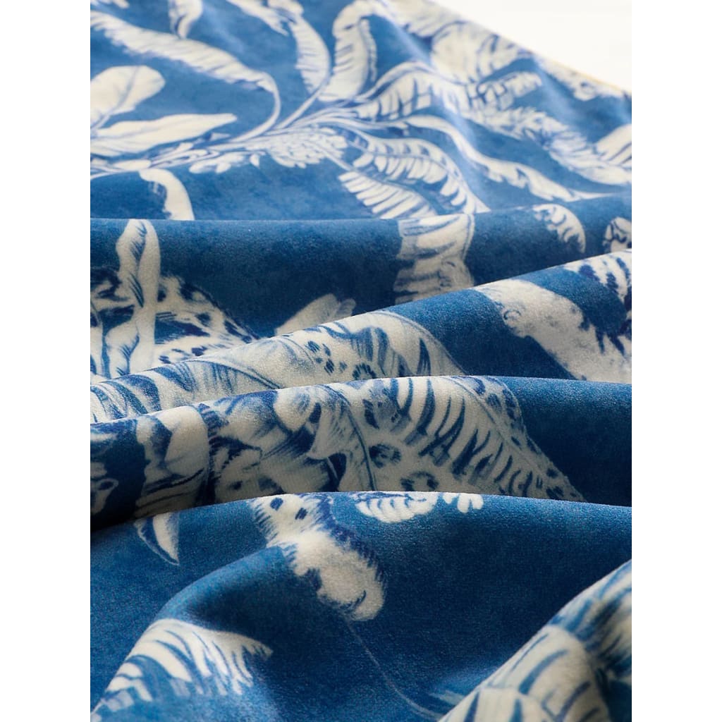 Close-up of a luxurious jungle-print throw pillow cover featuring intricate blue and white botanical patterns, perfect for adding a vibrant touch to home decor.