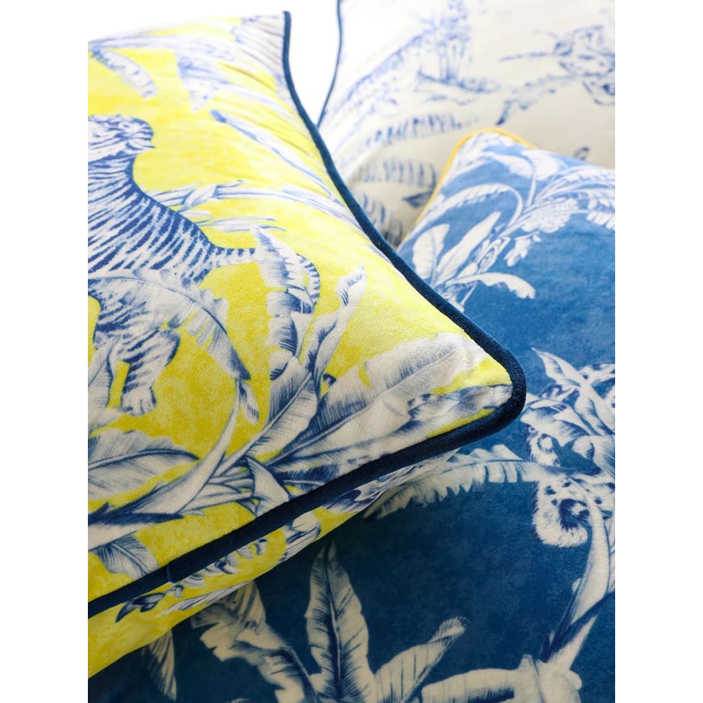 Colorful throw pillows featuring a jungle print with tigers and tropical leaves in vibrant yellow and blue hues.