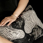 Luxurious throw pillow with zebra embroidery in black and gray, perfect for adding elegance to any decor.