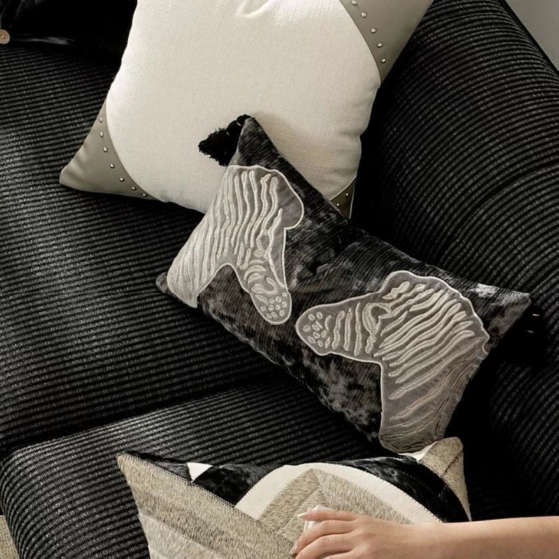 Luxurious black and gray throw pillow with zebra embroidery, perfect for enhancing home decor.