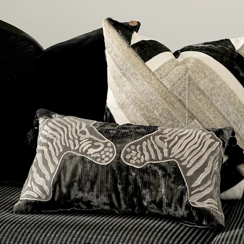 Luxurious black and gray throw pillow featuring zebra embroidery, perfect for adding a stylish touch to your home decor.