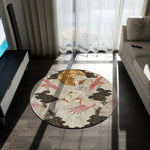 Round rug with Japanese crane and cloud motif, pink cranes circling a gold sun medallion on cream, styled in a living room