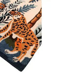 Stunning Majestic Jungle Dawn Hand Tufted Area Rug featuring an abstract tiger design in vibrant orange and black, set against lush green foliage. Perfect as a dining table rug or a standout piece in the living room. This wool rug, sized 8x10, adds a touch of exotic elegance to any dining room or living room setting.