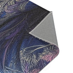 Folded corner of Majestic Monarch Regal Monkey Accent Rug showing dark blue coat with decorative pattern and gray backing