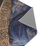 Folded corner of Majestic Monarch Regal Monkey Accent Rug showing gold crown scrollwork and dark background and gray backing